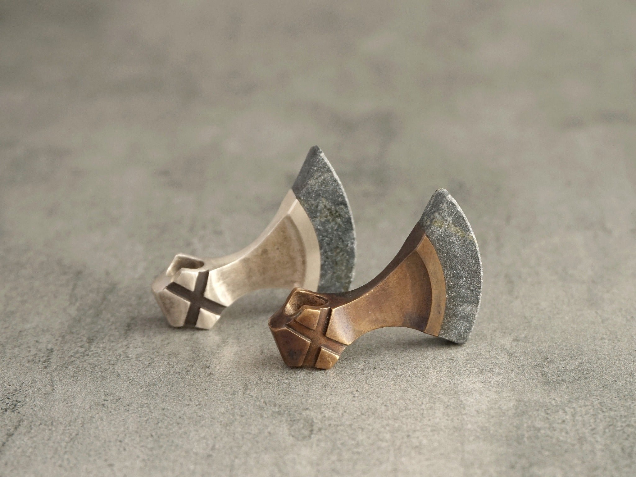 Two handmade axe necklaces. One in bronze, one in silver
