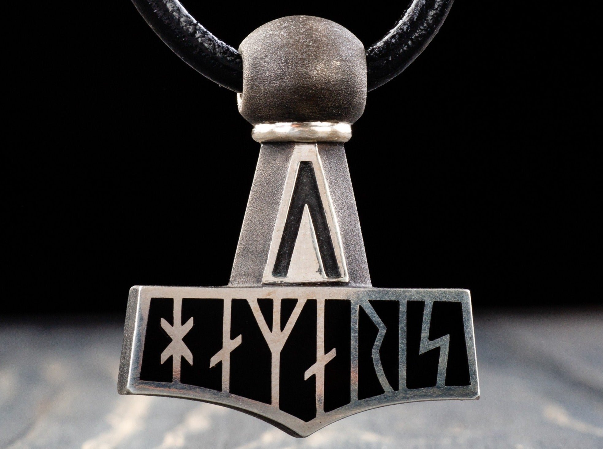 silver Thor's hammer amulet with black runes