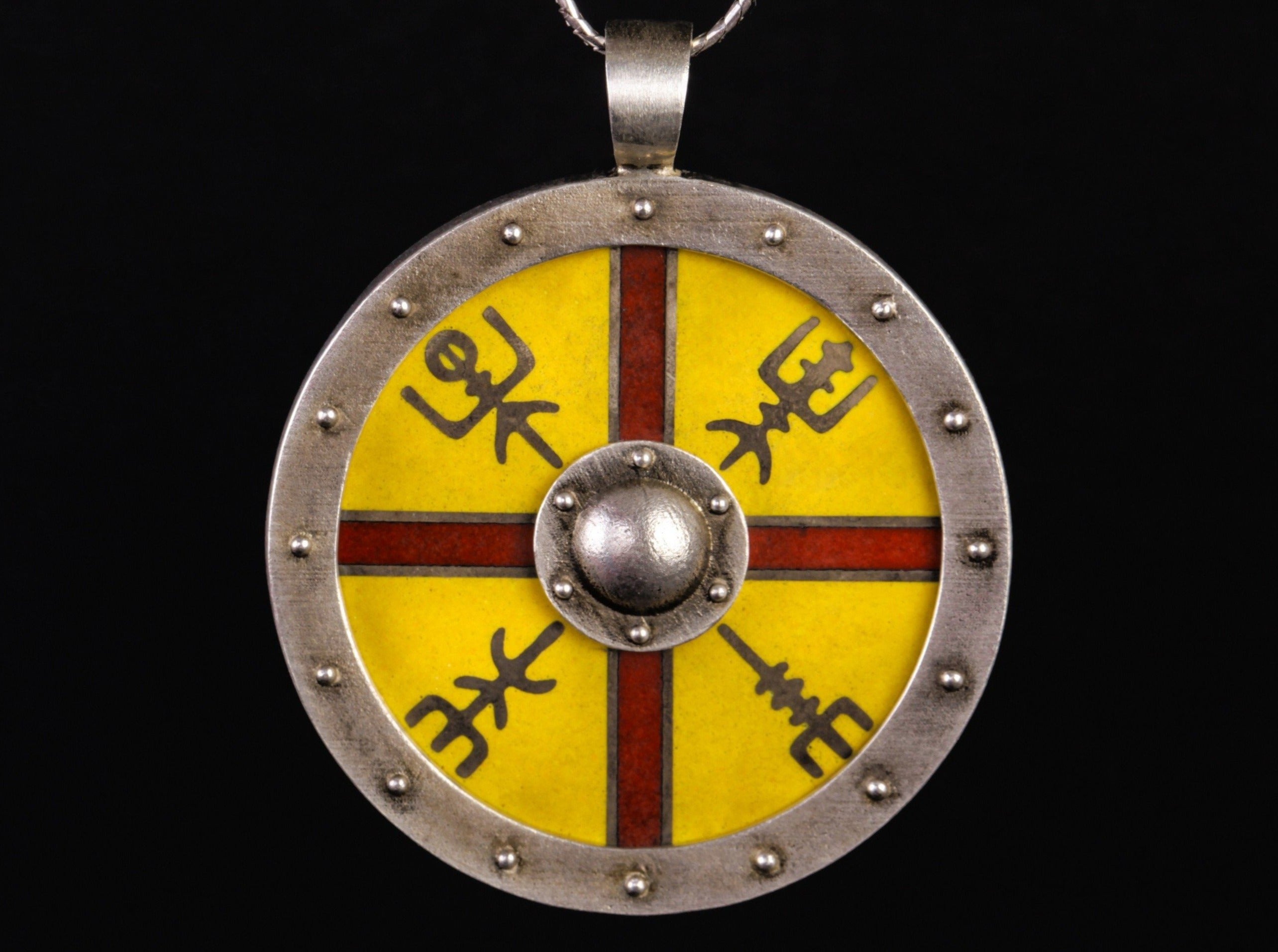 silver shield with cross and runes