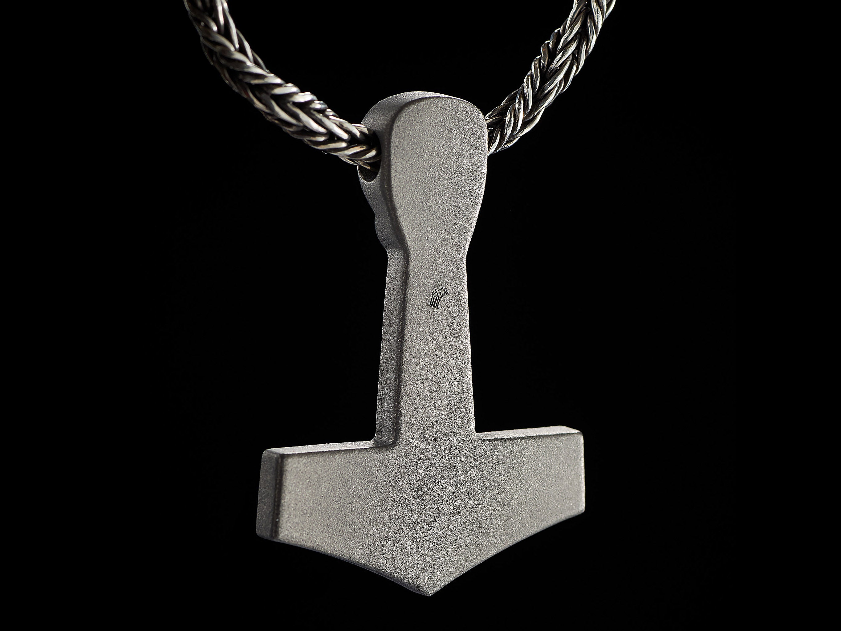 Back side of titanium Thor’s Hammer pendant with rough matte finish