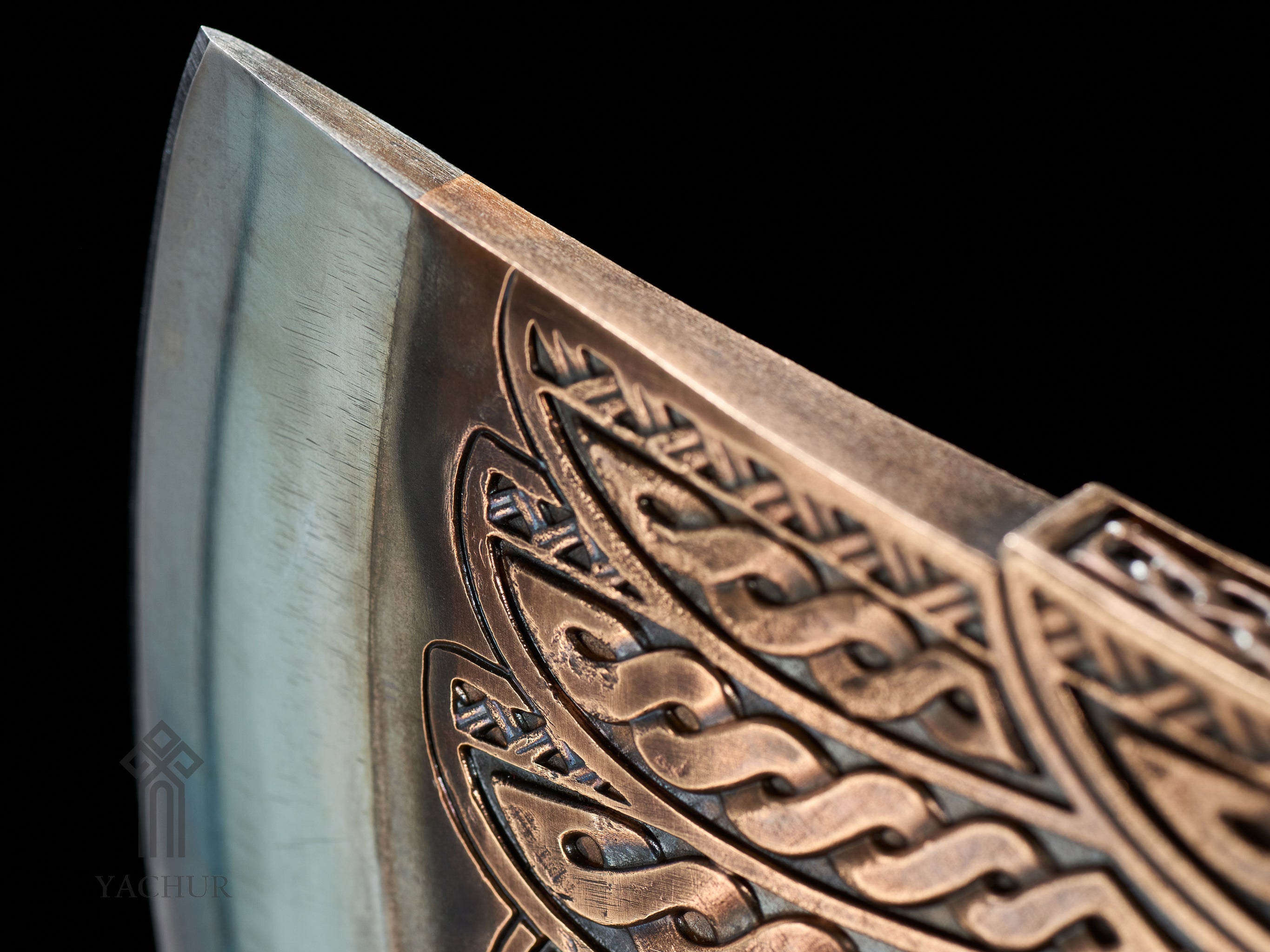 Detailed sculptural raven ornamentation on handcrafted Viking-inspired axe head