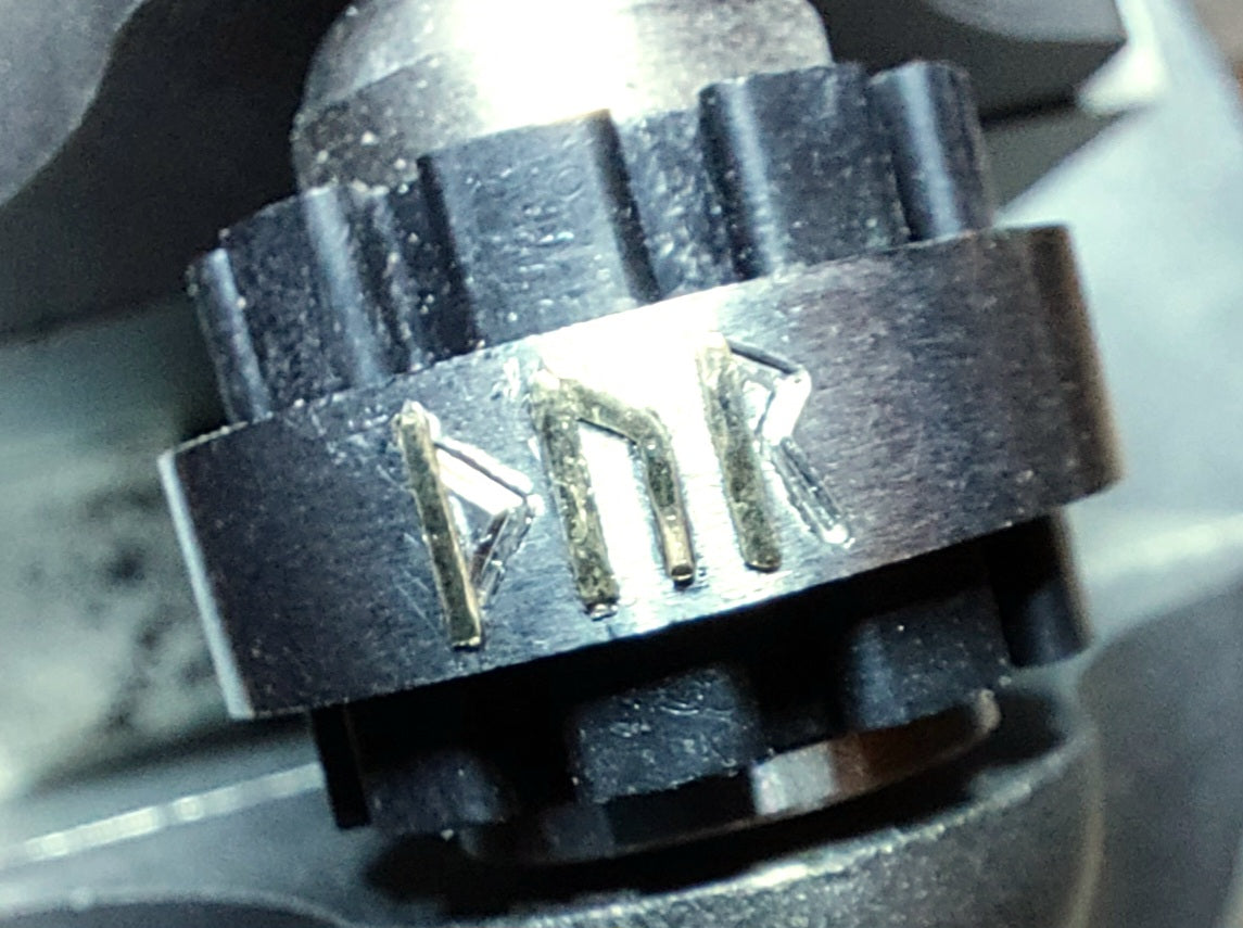 Traditional metal inlay process used to create a handcrafted Grade 2 titanium Thor rune ring with sterling silver or brass inlay.