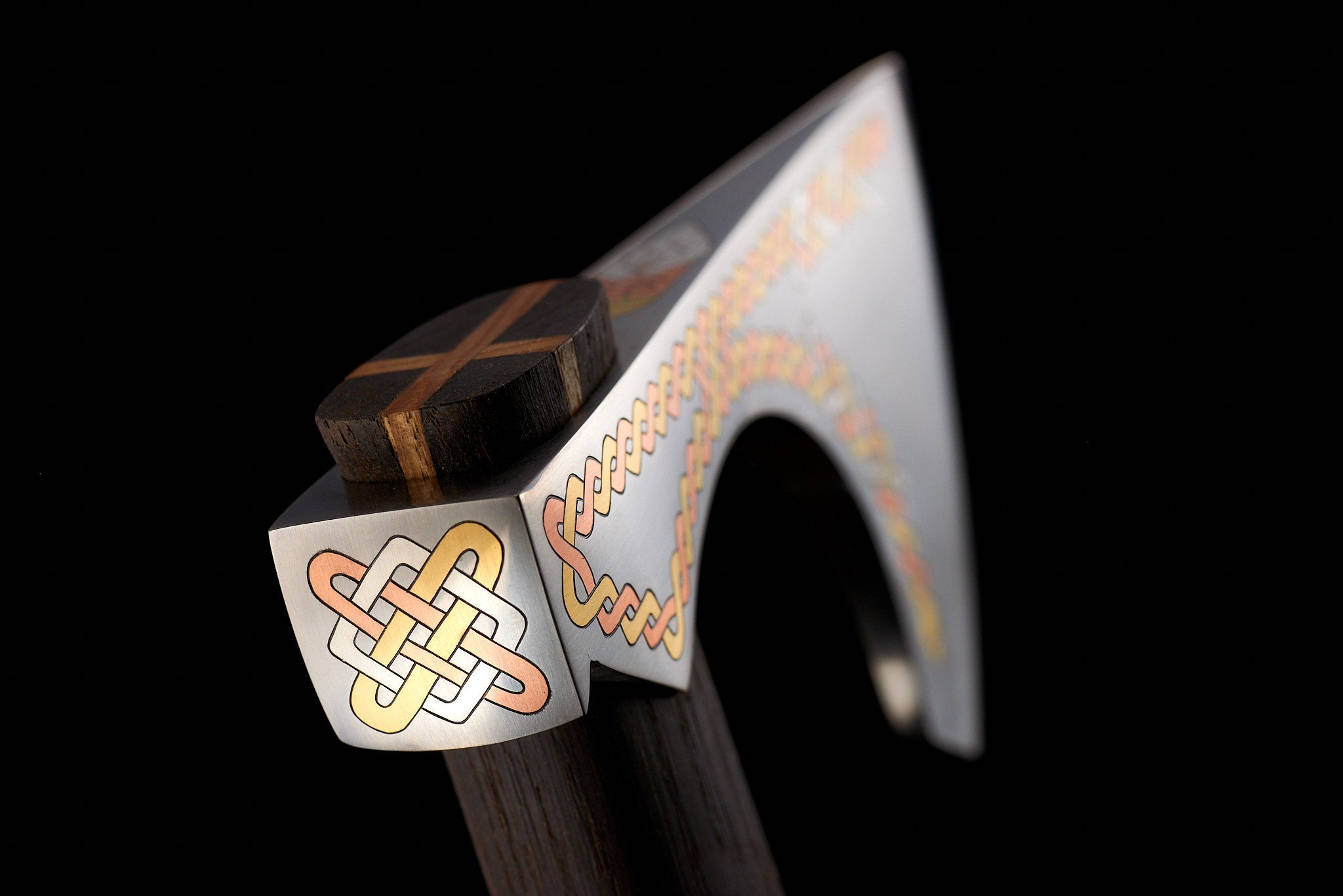 Macro detail of complex hand-applied metal inlay work