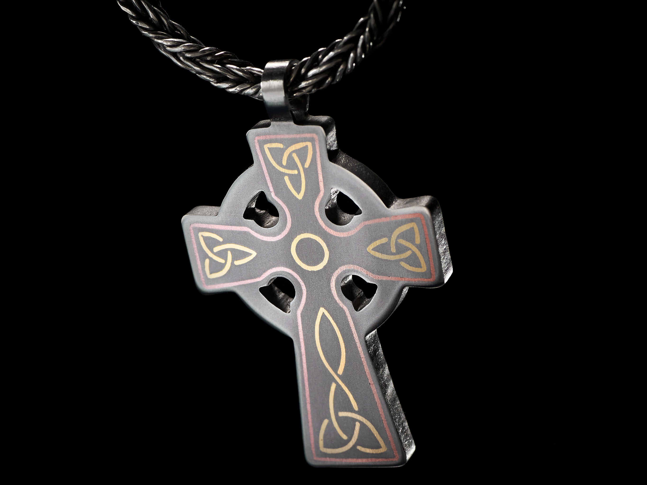 detail of titanium celtic cross pendant brass and copper inlay
