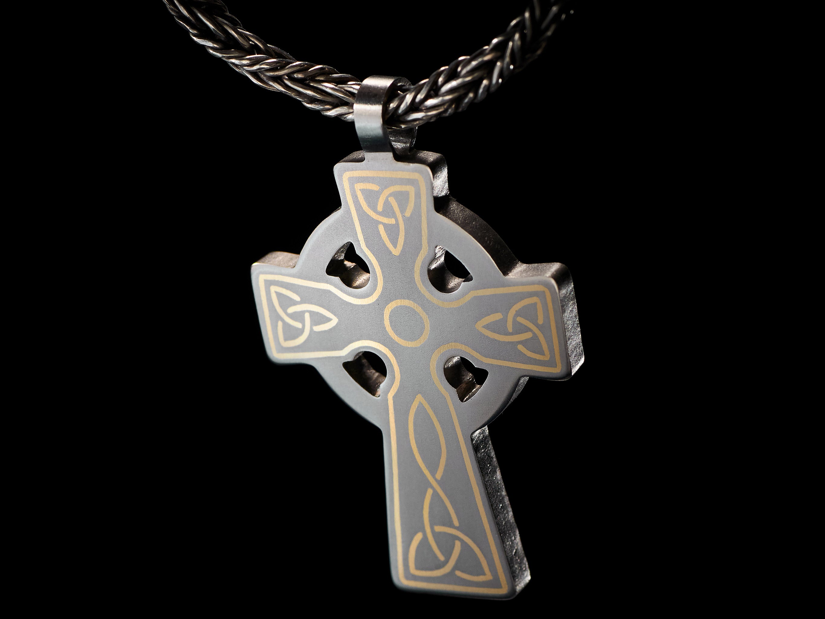 detail of titanium celtic cross pendant brass inlay