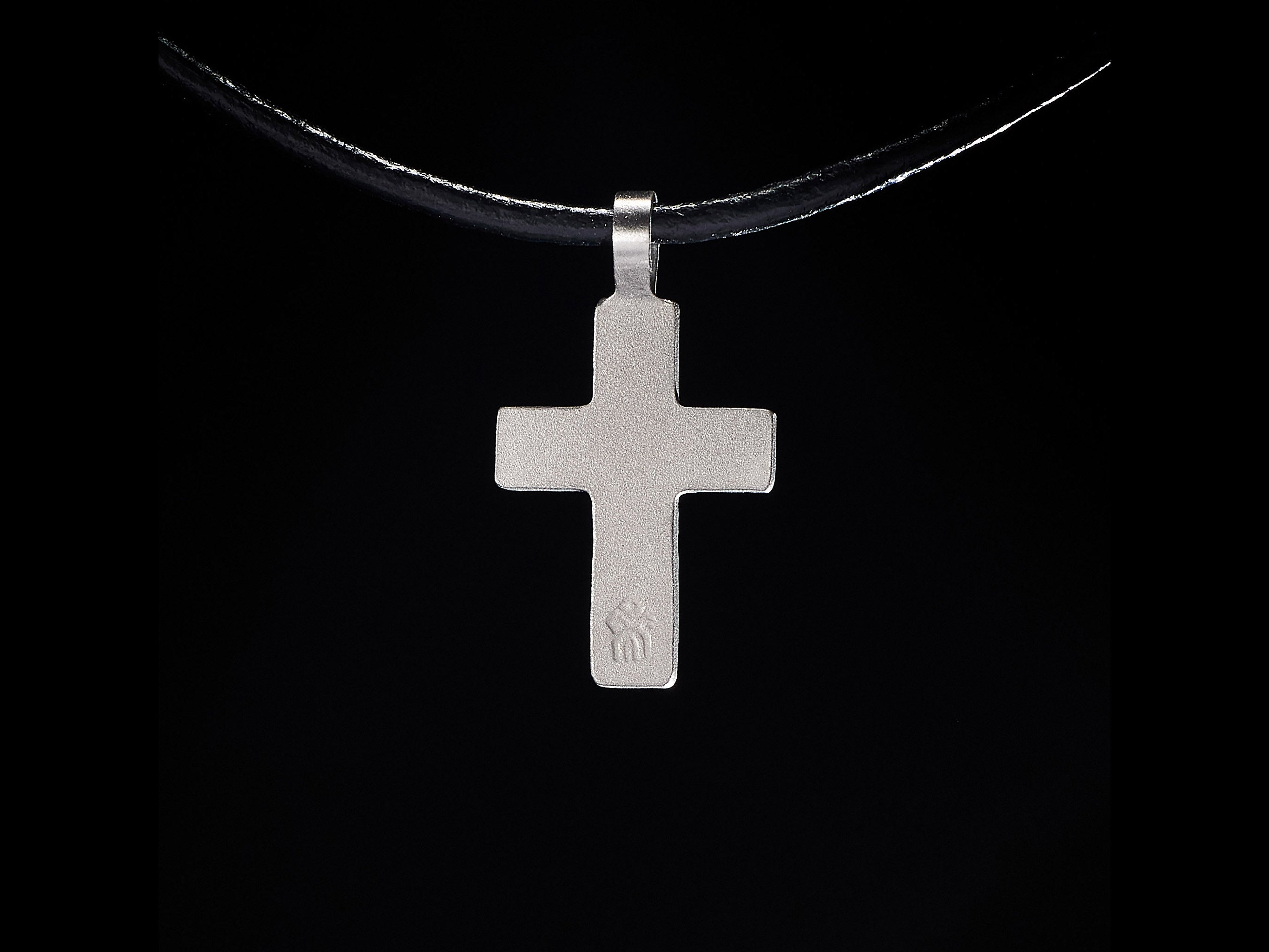 Back side of handmade titanium cross pendant showing clean minimalist finish