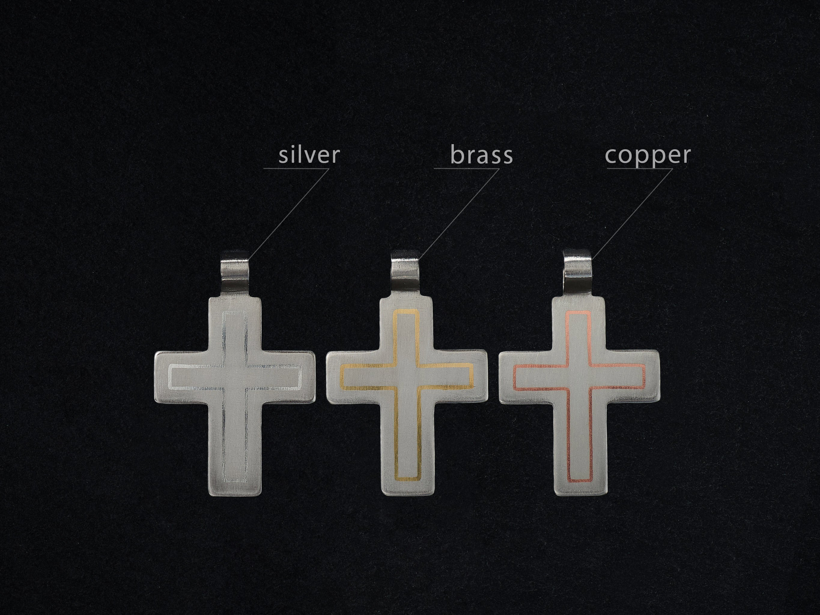titanium cross pendant showing silver brass and copper inlay options comparison