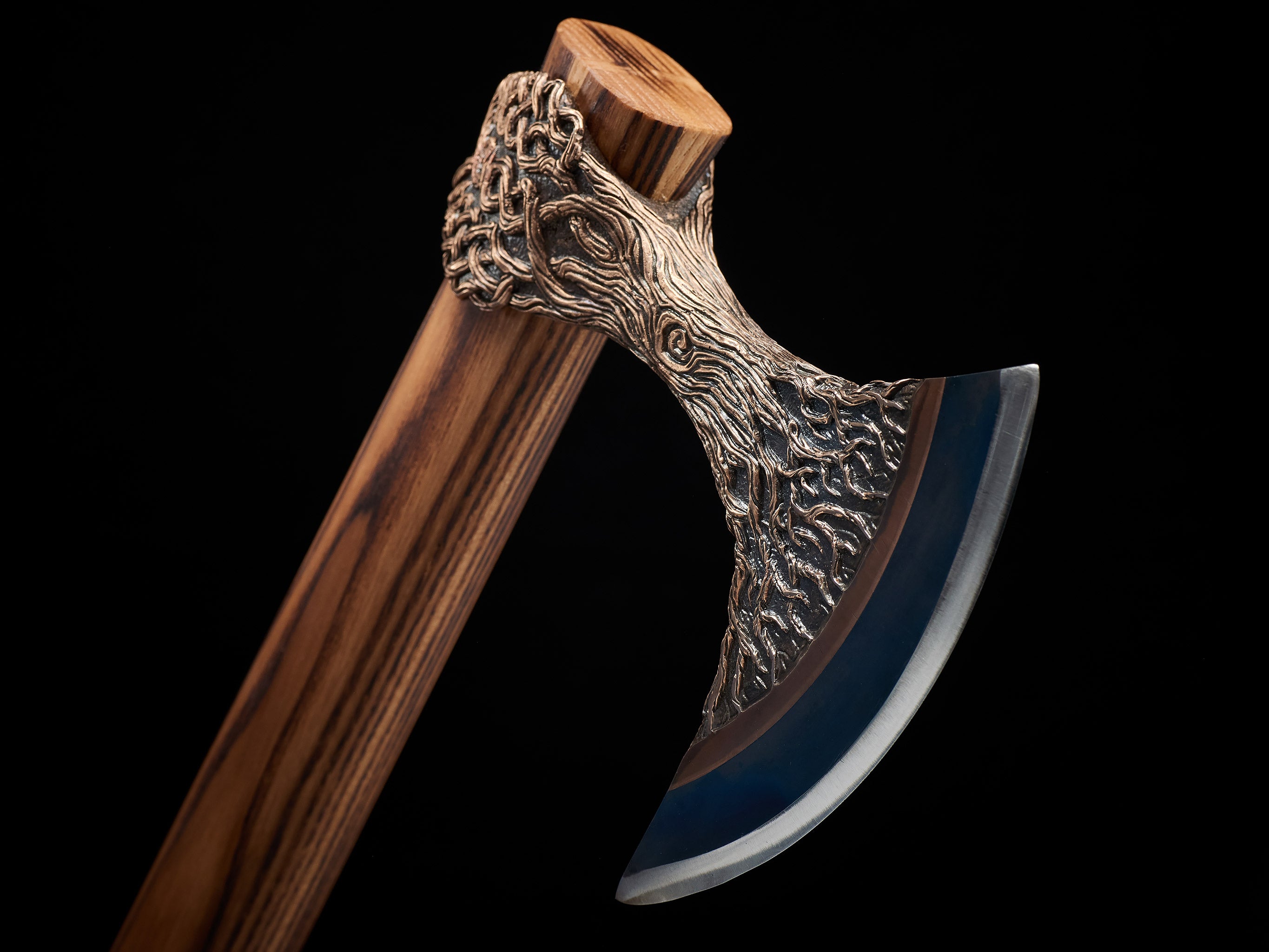 Close artistic view of handmade Viking axe and bronze details