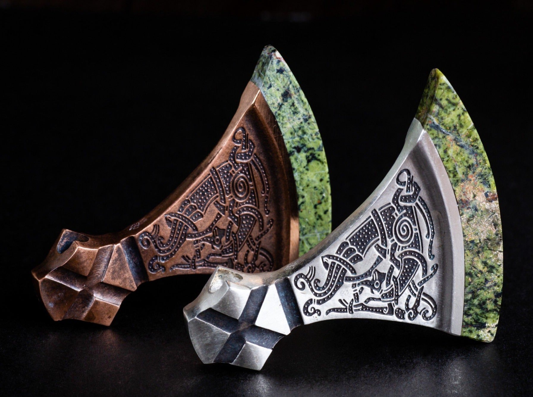 large silver and bronze axes with green blades