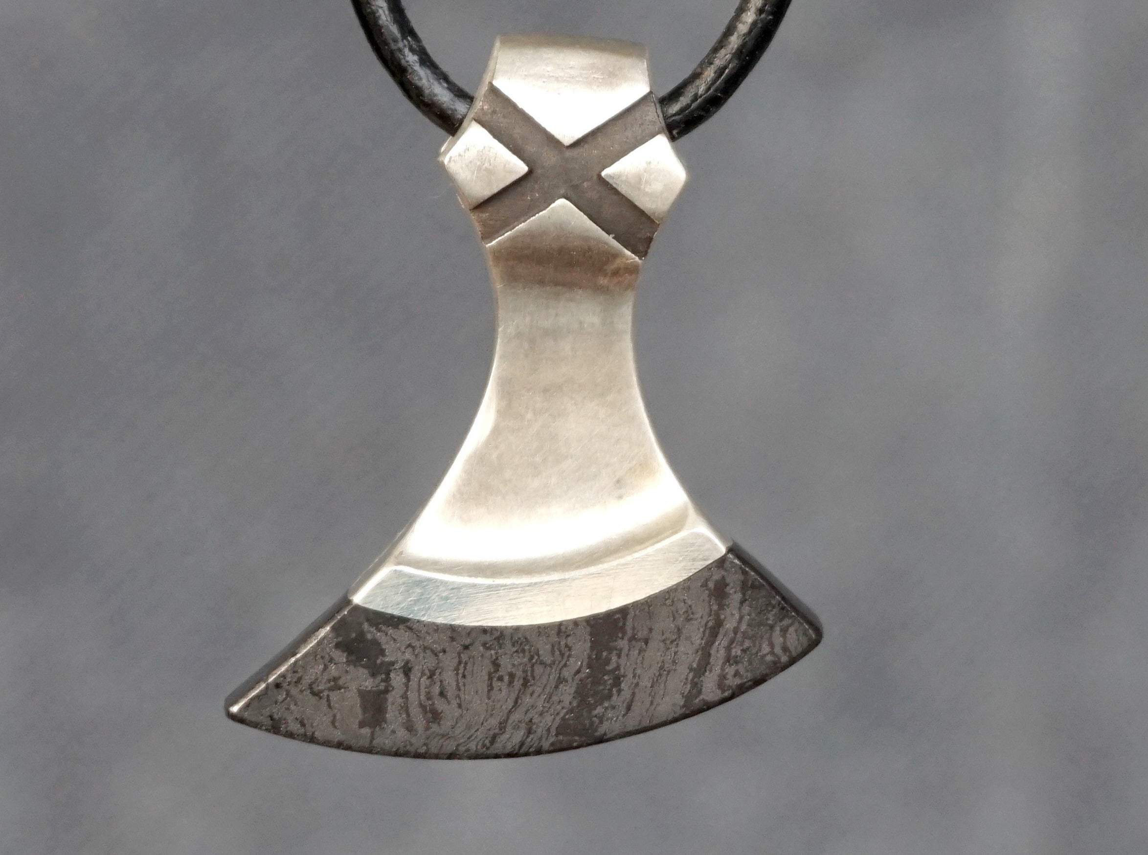 small silver axe with hematite blade
