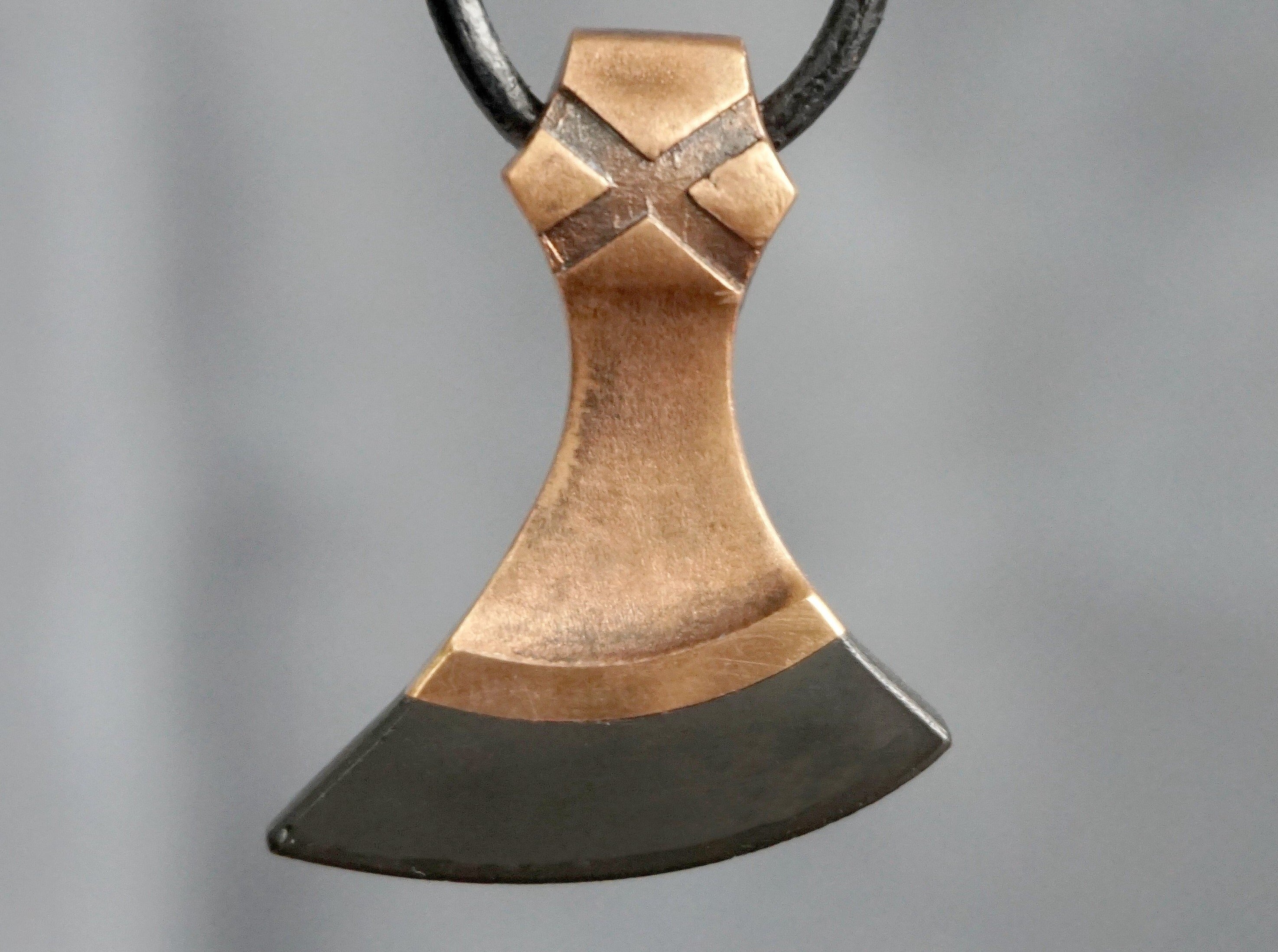 bronze axe with black stone edge 