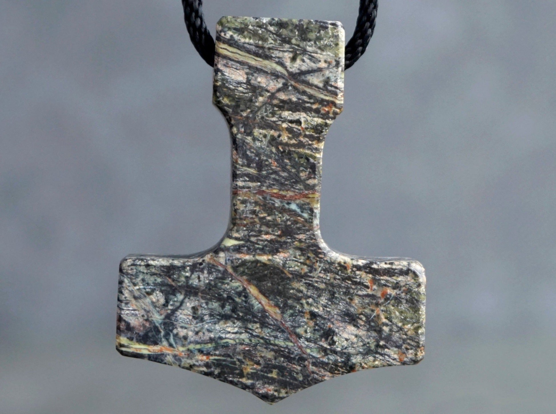 Thor's hammer amulet carved out of multicolored Serpentine stone
