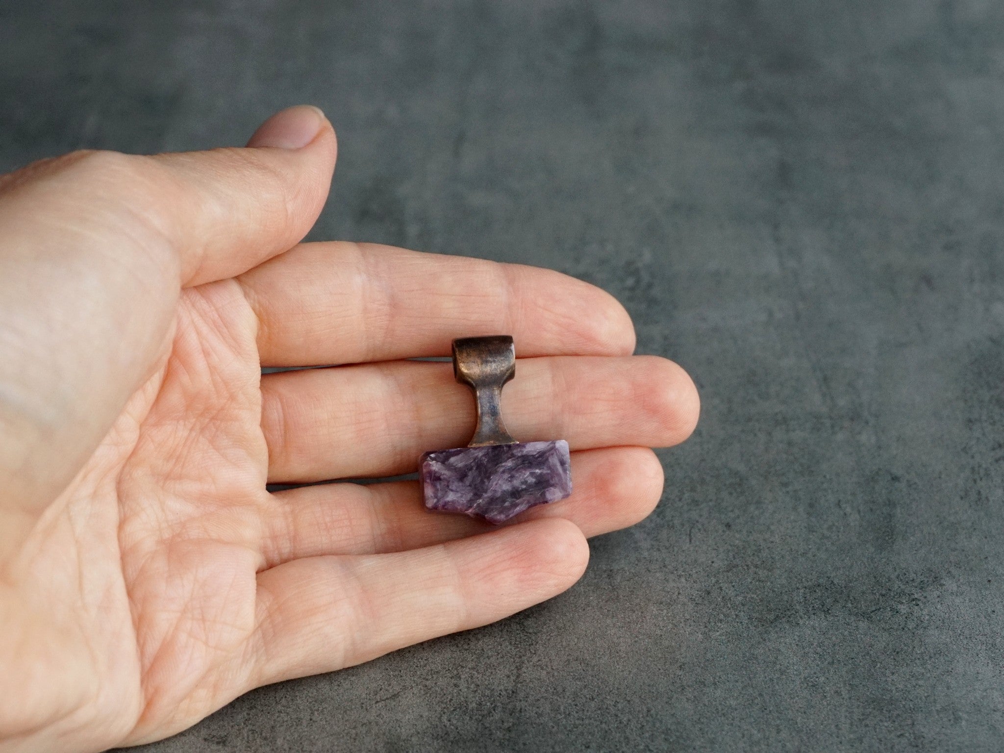 small bronze and purple stone hammer pendant