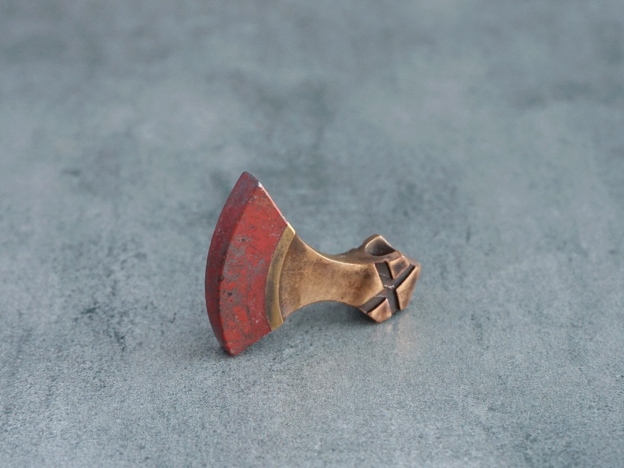 small bronze and red jasper axe amulet