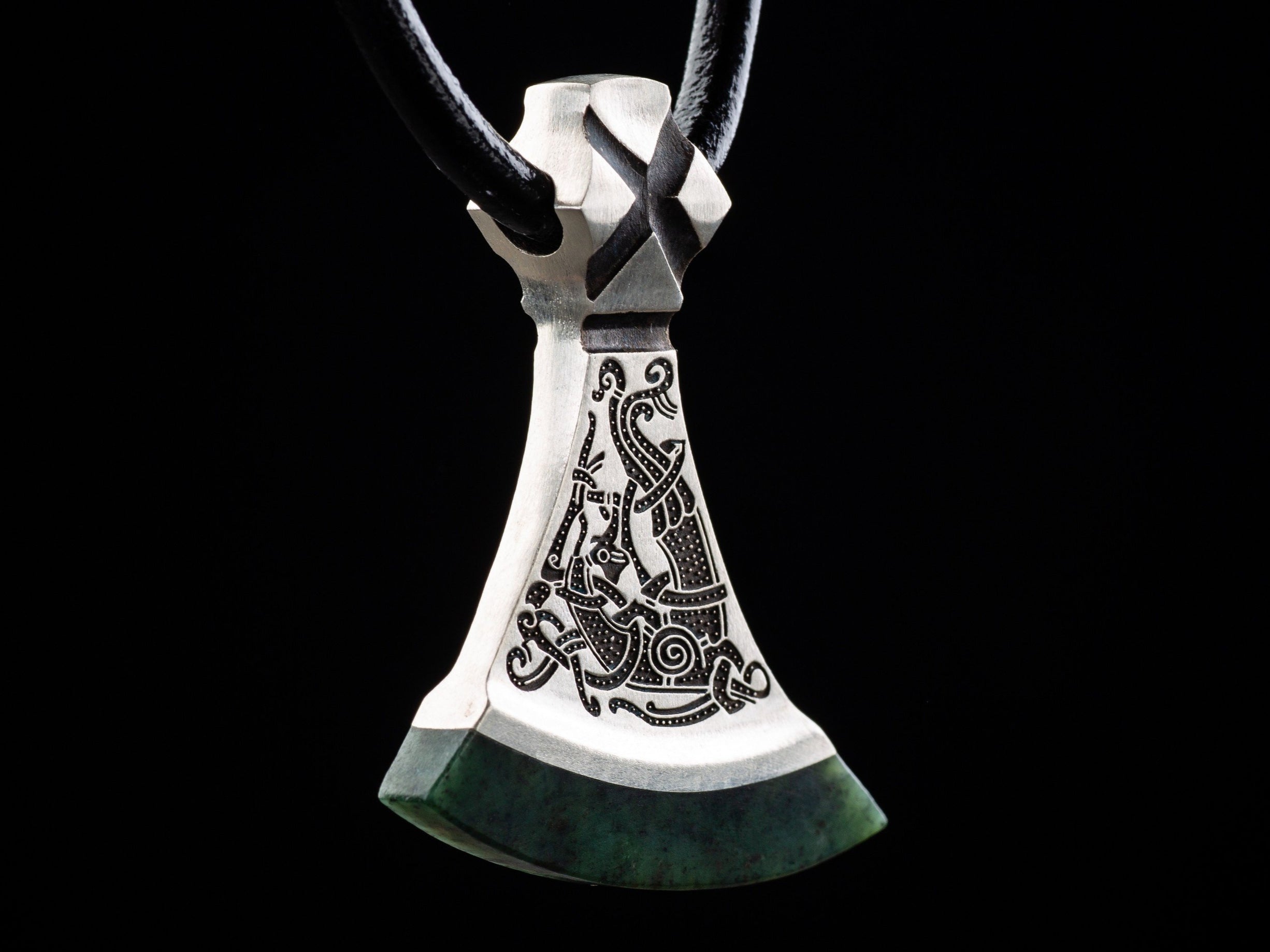 bird ornament on a silver axe