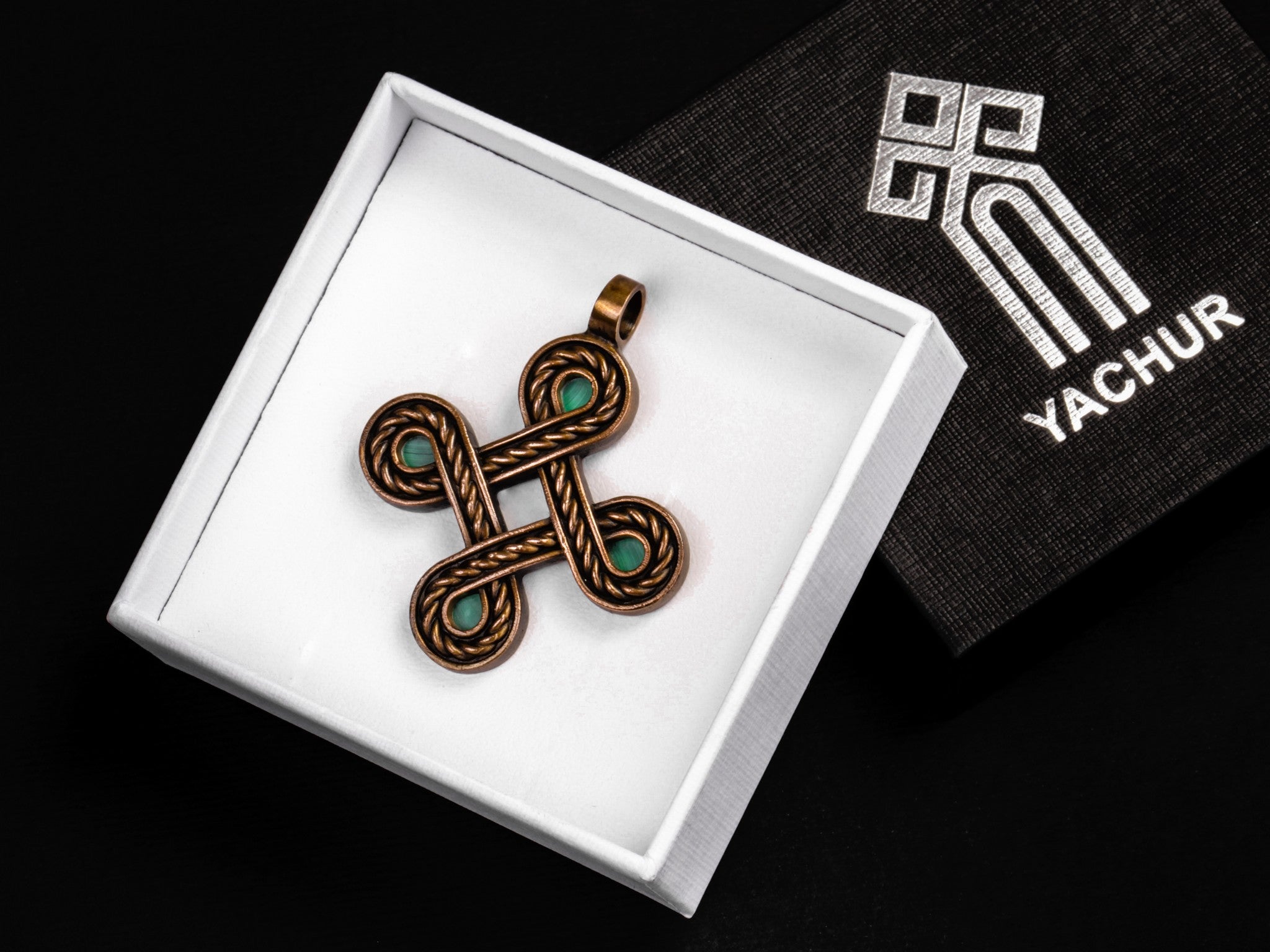 bronze cross in a branded gift box