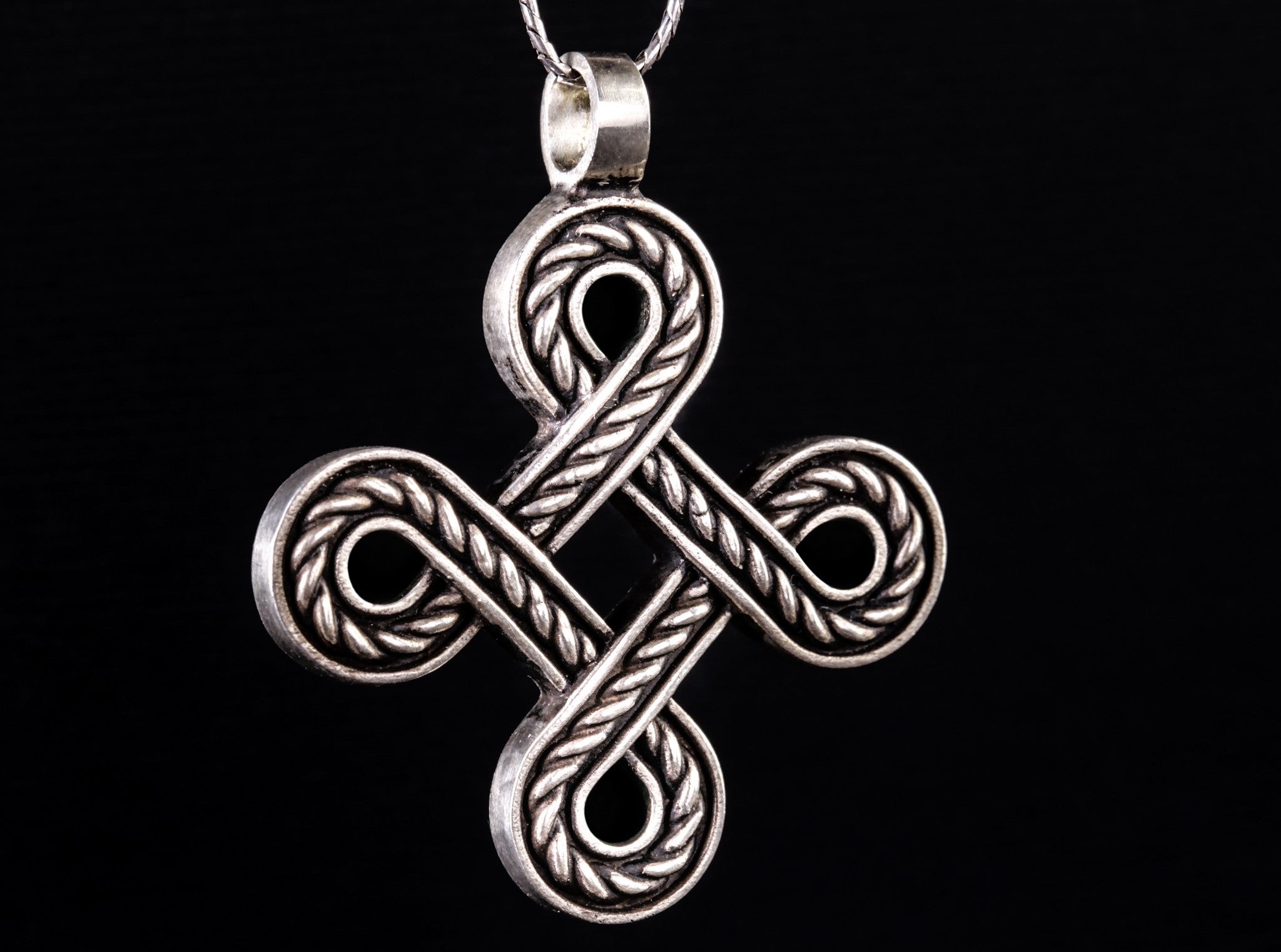 large rope-like silver cross
