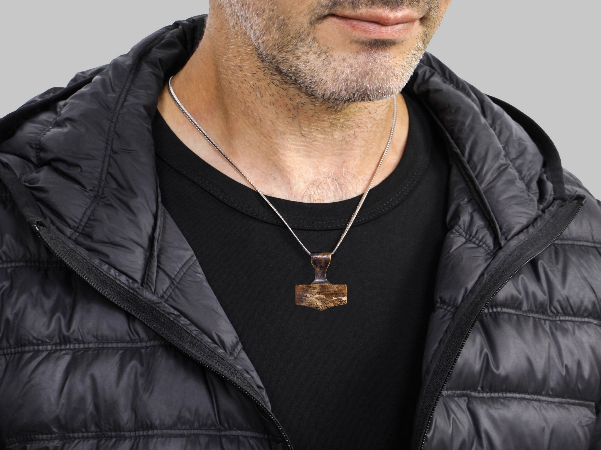 medium size hammer pendant made of bronze and petrified wood