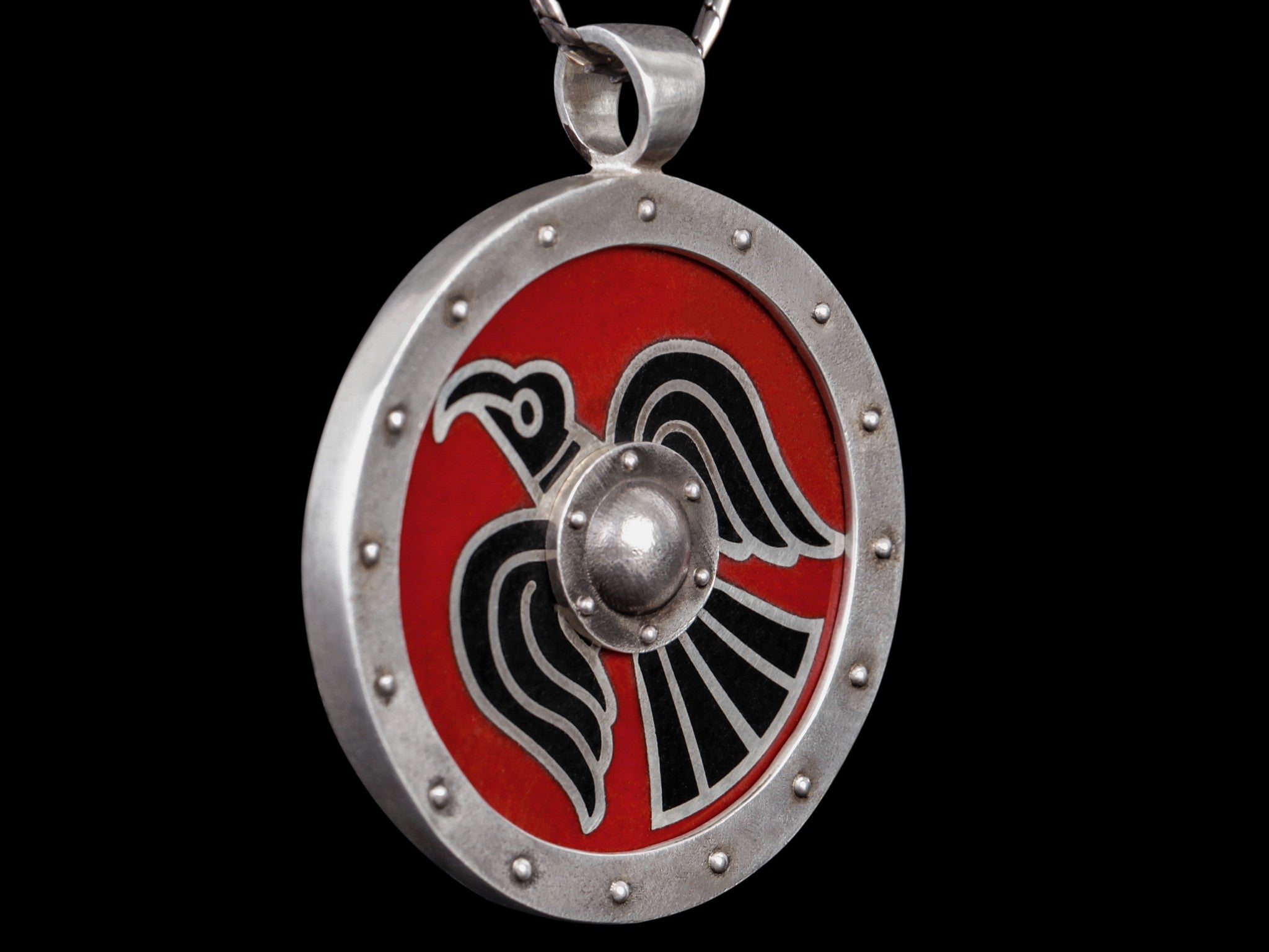 silver shield with black raven on the red background 